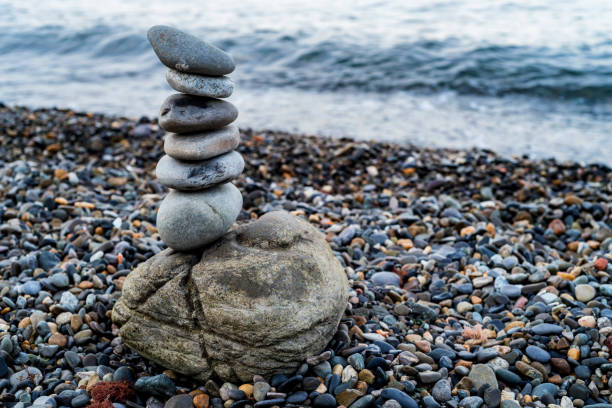 istock Stone tower of pebbles on sea shore 995604370