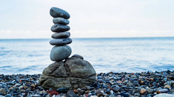 istock Stone tower of pebbles on sea shore 995606414