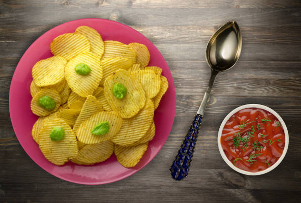 istock potato chips on a plate. chips on a wooden 995608690
