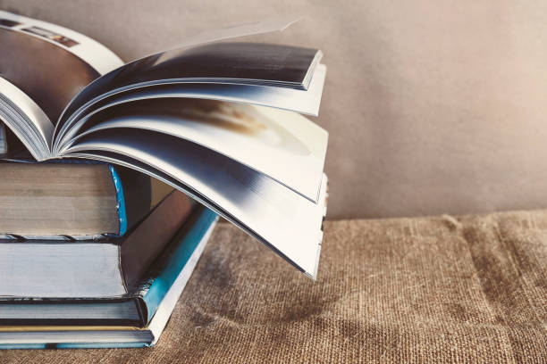 istock Old textbook stack on the sackcloth with the book turning pages on top 995608898