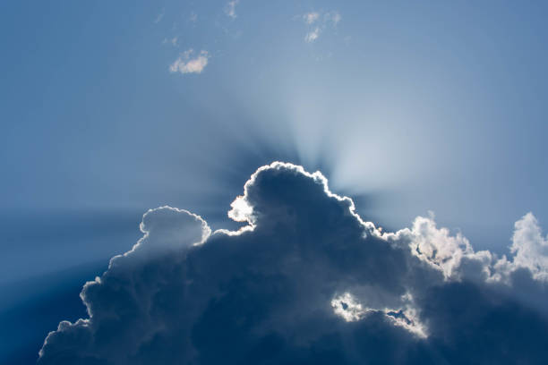 Rays of sunlight emerge from behind a cloud over Inle Lake.