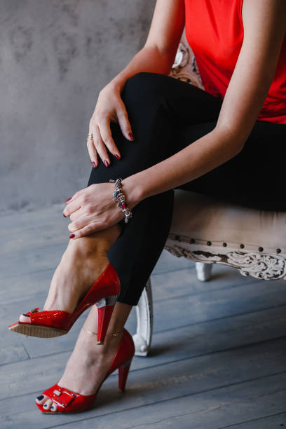 istock A woman wearing her red heels sitting on a stool. 995624128