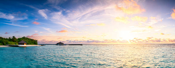 istock Beautiful sunset over ocean island maldives long panorama 995629254