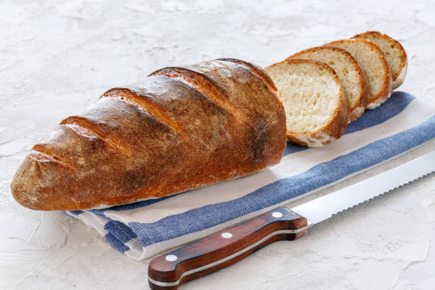 istock Freshly baked loaf cut into slices. 995638754
