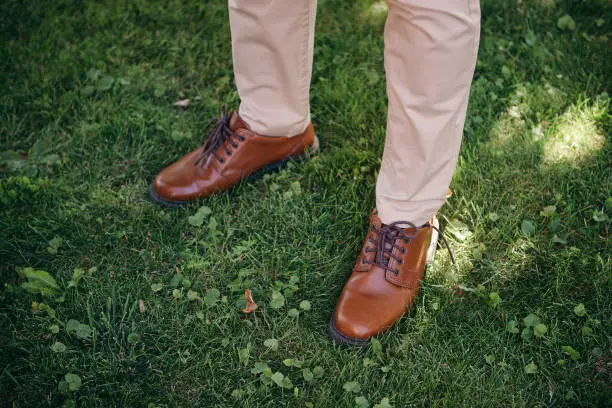 Photo of Man brown shoes on grass