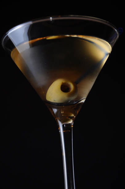istock Dry Martini Cocktail with Olive on Black 995658786