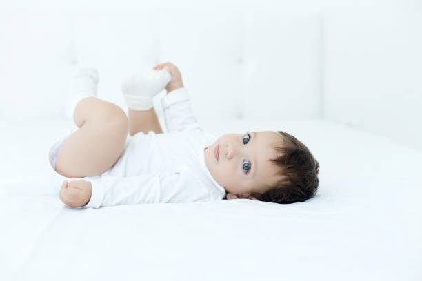 Baby girl lying on bed