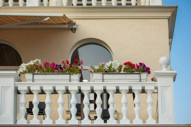 istock Beautiful balcony in a house with white columns and flowers in boxes. 995671146