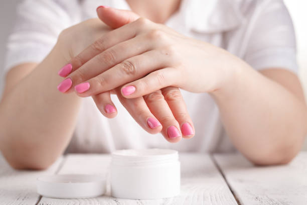 istock beautiful woman hands with cream 995676448