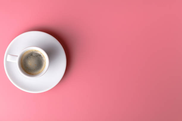 istock One small cup of coffee on pink background 995692700