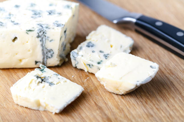istock blue cheese on a wooden background with knife 995692748