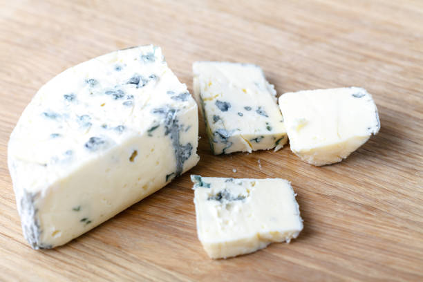 istock blue cheese on a wooden background with knife 995701232