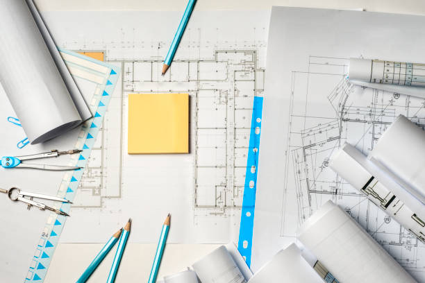 istock Workplace of architect - rolls and plans. 995701522