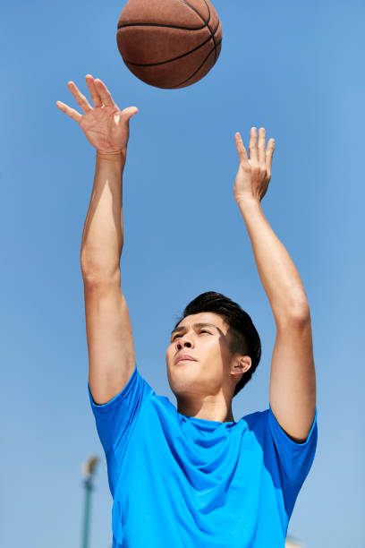 istock young asian basketball player making a jump shot 995701614