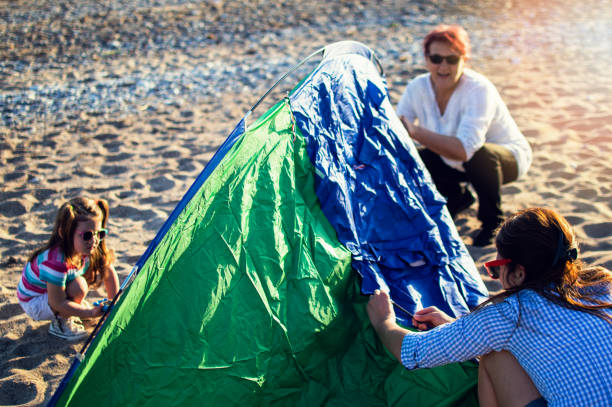 istock Multi generation girls family camping at the beach 995704214