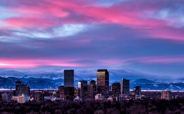 Denver Sunset Skyline Photography of the Denver Skyline at Sunset with snowy winter peaks in distance. denver photos stock pictures, royalty-free photos & images