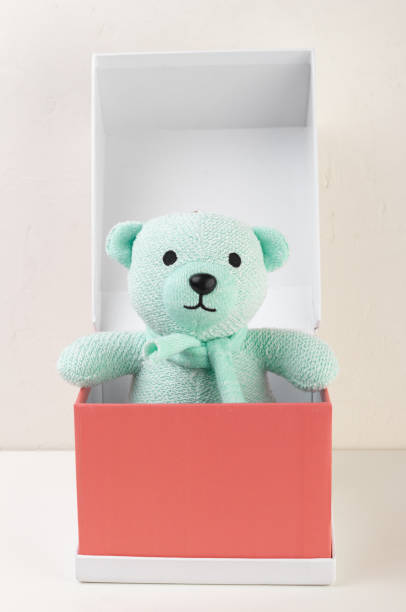 istock bear toy in a red cardboard box 995717290