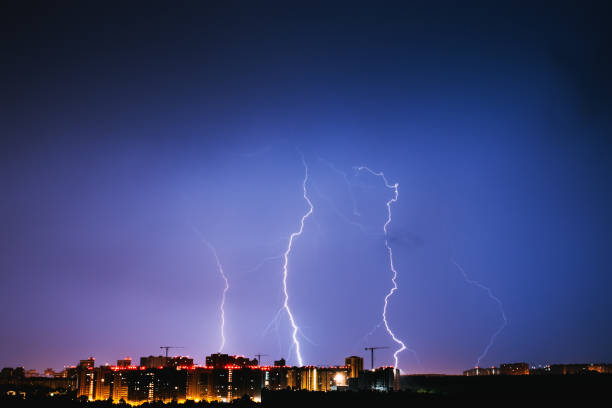 istock Thunderstorms vivid blue sky and lightnings above night city 995728262
