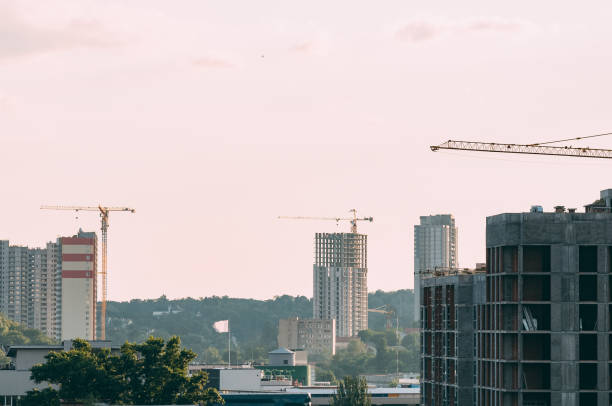 istock Construction of a high-rise building with a crane. Building construction using formwork. The construction crane and the building against the blue sky. 995730772