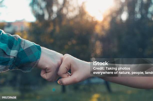 Team Partners Giving Fist Bump Stock Photo - Download Image Now - Respect, Teenager, Handshake