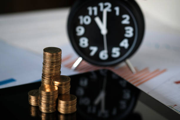 istock Step of coins stacks and alarm clock with tablet computer and financial graph, business planning vision and finance analysis concept. 995745578