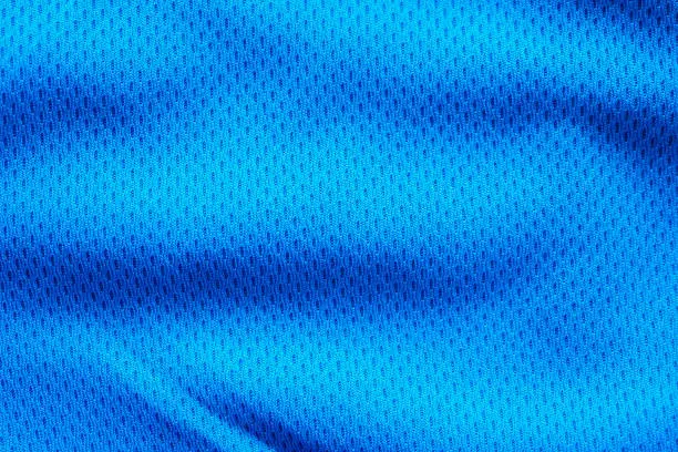 Photo of Blue fabric sport clothing football jersey with air mesh texture background