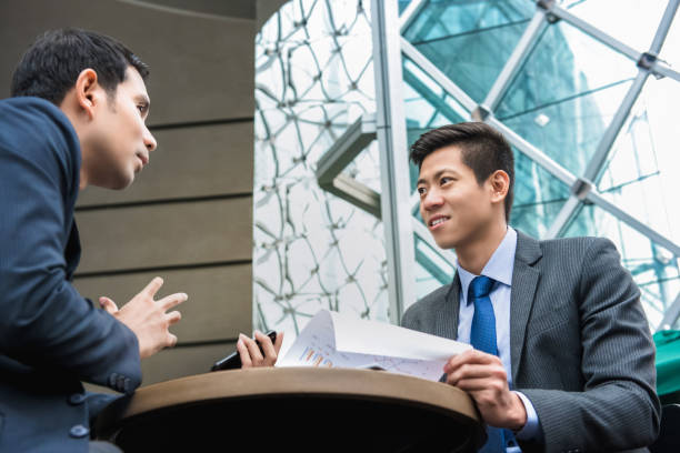 istock Young Asian business partners discussing work 995746512