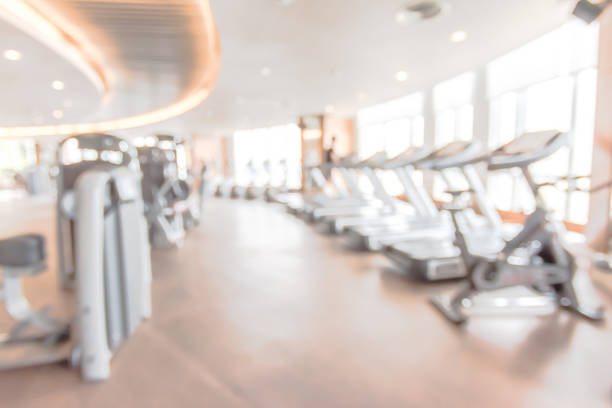 Blur gym background fitness center or health club with blurry sports exercise equipment for aerobic workout and bodybuilding Blur gym background fitness center or health club with blurry sports exercise equipment for aerobic workout and bodybuilding aerobics photos stock pictures, royalty-free photos & images