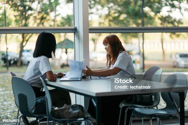 Young Asian Students In Uniforms Studying Together In Bangkok Thailand Stock Photo - Download Image Now