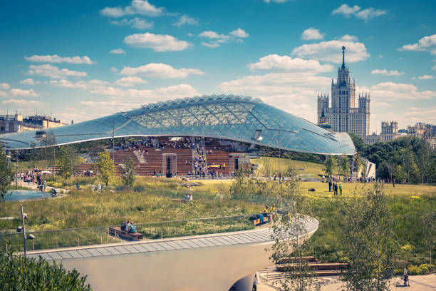 Moscow - June 17, 2018:  Modern amphitheater with glass dome in landscaped Zaryadye Park in Moscow, Russia. Zaryadye is one of the main landmarks of Moscow. Scenic view of the Moscow center in summer.