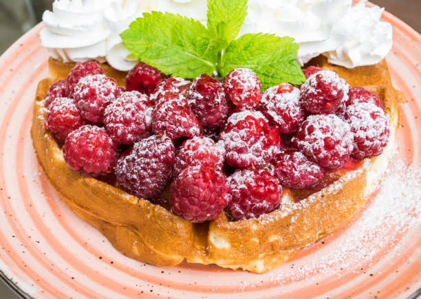 Waffles with raspberries and whipped cream