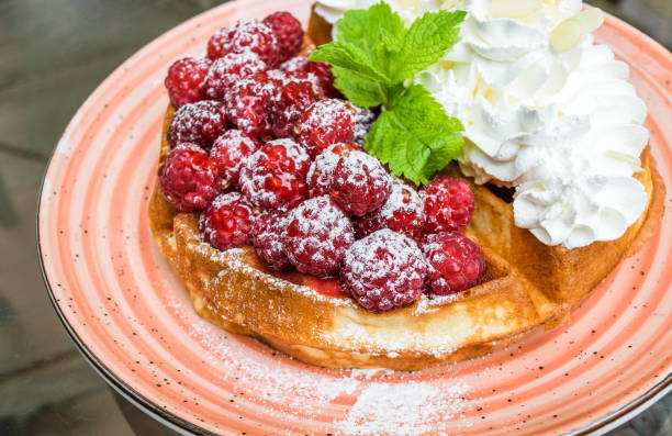 Waffles with raspberries and whipped cream