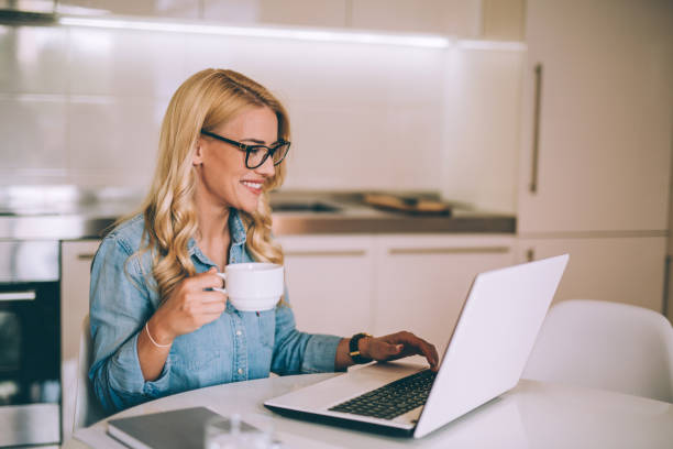 istock Young woman drinking coffee in the morning in her kitchen 995778522