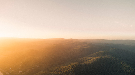 Aerial View of Trees Covering Hills in Great Ocean Road National Park, Australia at Sunset.