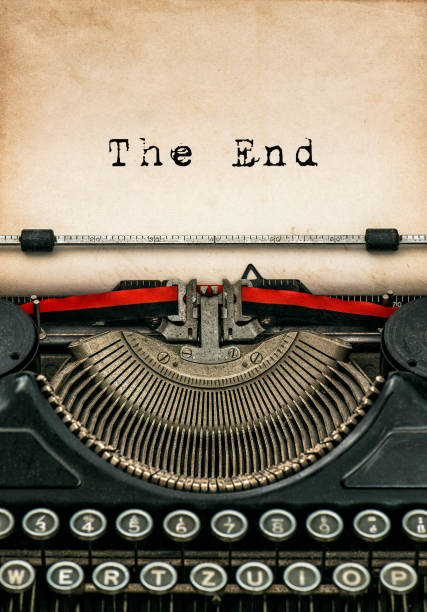 Antique typewriter with aged textured paper sheet. Sample text The End