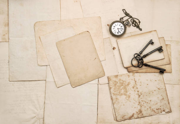 istock Vintage letters keys pocket watch paper background 995786780