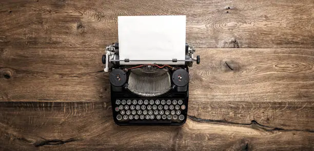 Photo of Antique typewriter grungy textured paper wooden background