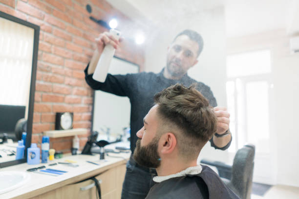 istock Hairdresser using hairspray 995791276