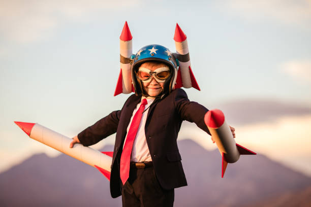 istock Young Business Boy in Helmet Holding Rockets 995808228