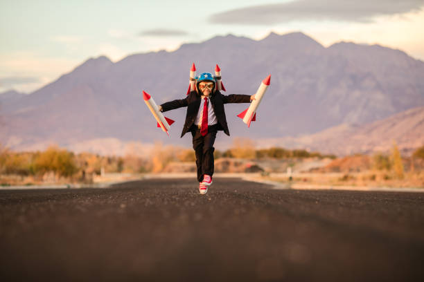 istock Young Business Boy Takes Off with Rockets 995808244