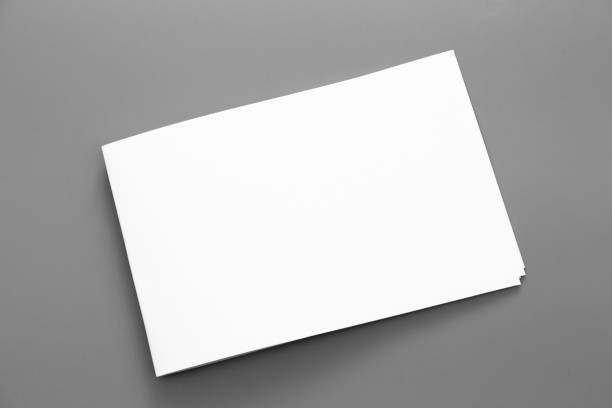 istock Blank portrait A4. brochure magazine isolated on gray, changeable background / white paper business card isolated on gray 995808406