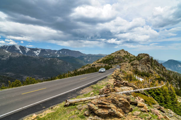 trail ridge road - a stormy spring day view of a narrow section of trail ridge road winding at top of mountains. rocky mountain national park, colorado, usa. - storm summer forest cloudscape imagens e fotografias de stock