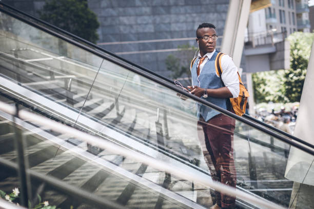 Handsome Young African Man Walking Rapidly To Catch Train At Railroad Station