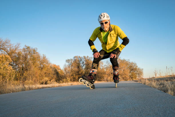 Senior athletic male  is inline skating on the Poudre River Trail in Colorado, late fall scenery