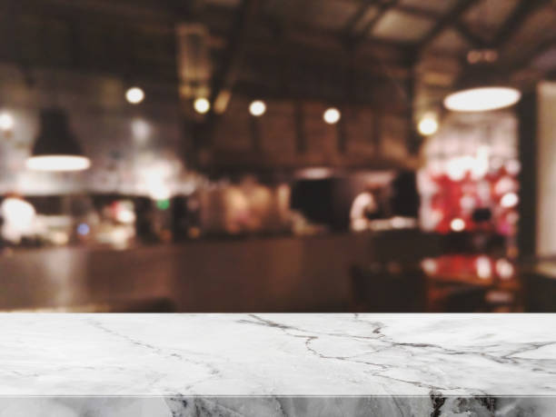 istock Empty white marble Stone table top and blurred restaurant interior background - can used for display or montage your products. 995887294
