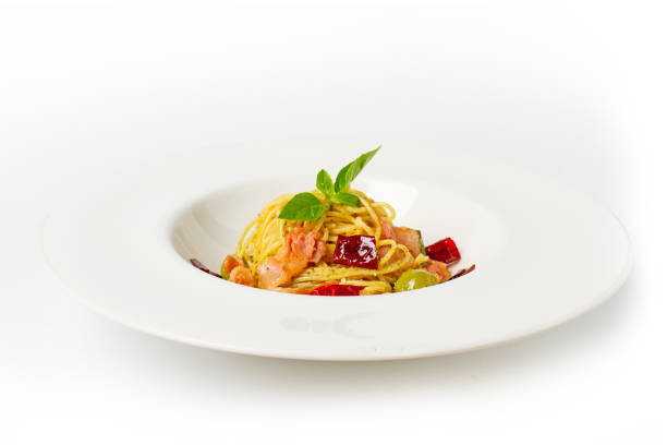 istock Spaghetti with bacon, dry chili, green olive in white dish top view on white background 995887420