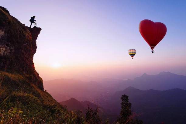 Beautiful colorful hot air balloons flying over mountain at view point Sunset of travel place, Doi inthanon, Chiang mai's Hidden Paradise in Thailand.