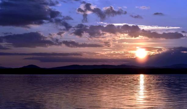 istock dark blue and orange evening sky over the lake 995893952