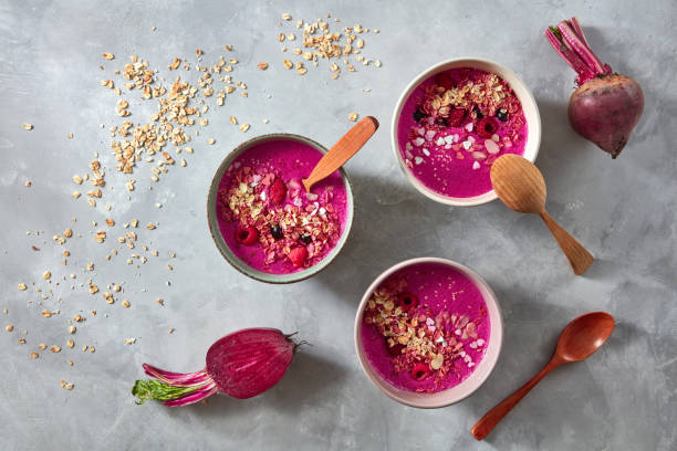 healthy breakfast bowl with beetroot, oat flakes and berry on stone background, flat lay - vitality food food and drink berry fruit imagens e fotografias de stock