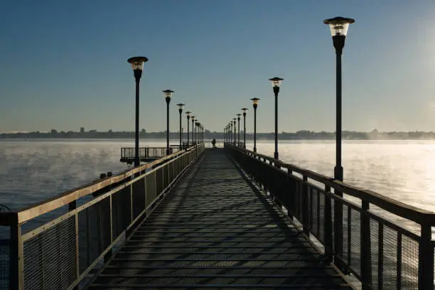 Pedestrian walkway over the Parana River in a foggy and cold morning, Posadas, Argentina